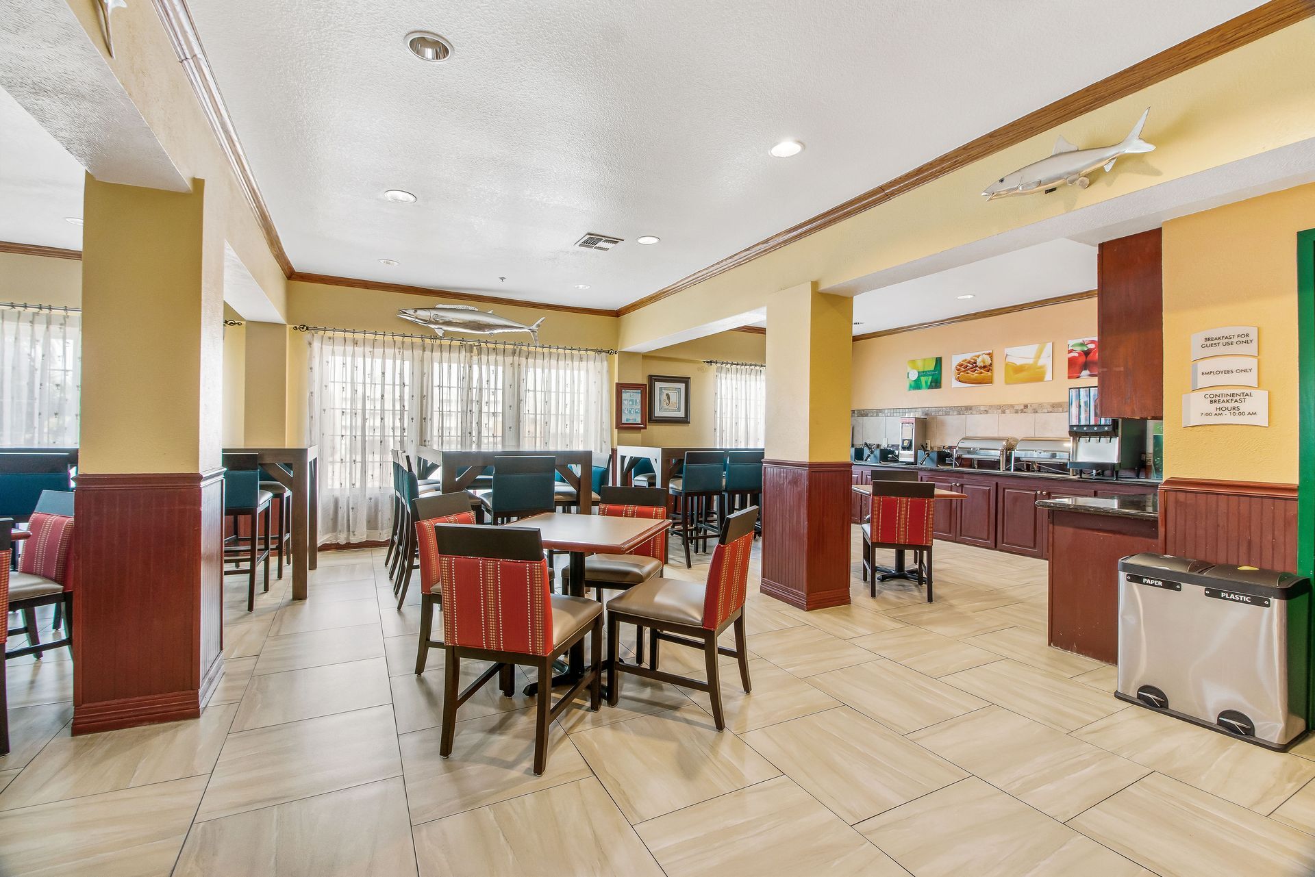 A large dining room with tables and chairs in a hotel.