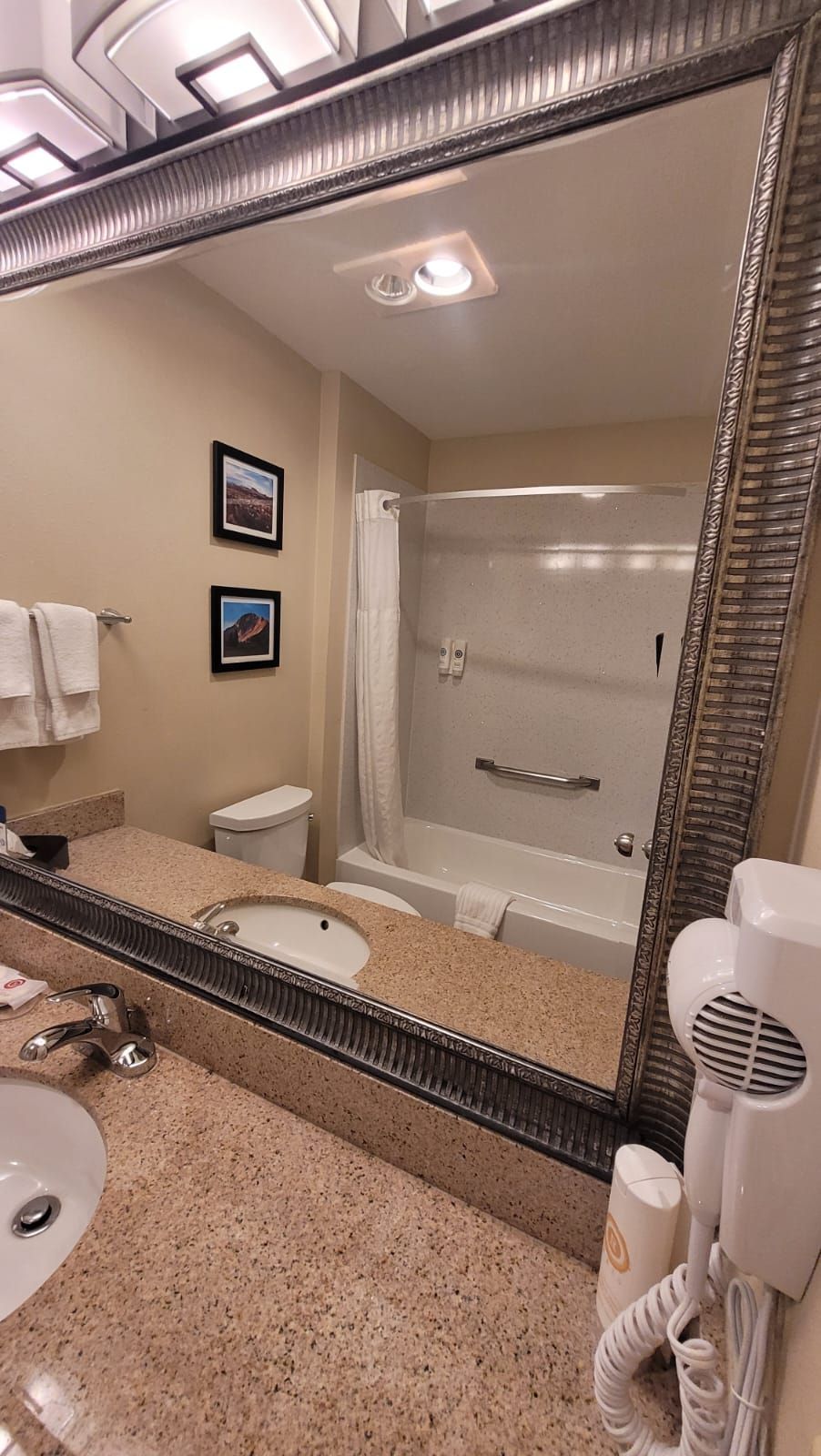 A bathroom with a sink , toilet , bathtub and mirror.