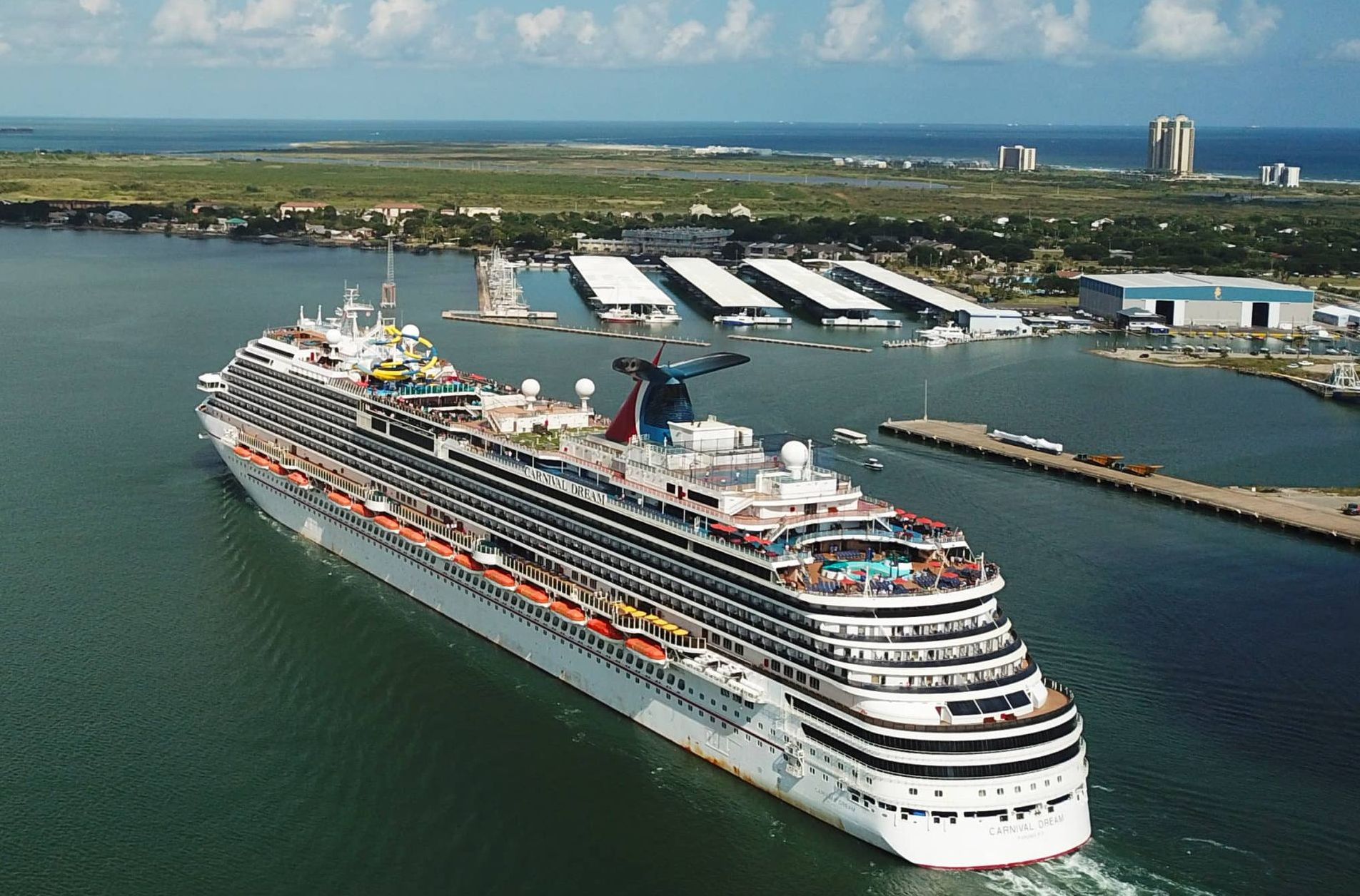 A large cruise ship is docked in a harbor