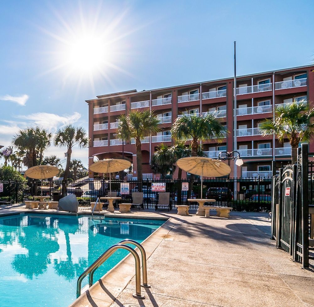 A large building with a swimming pool in front of it