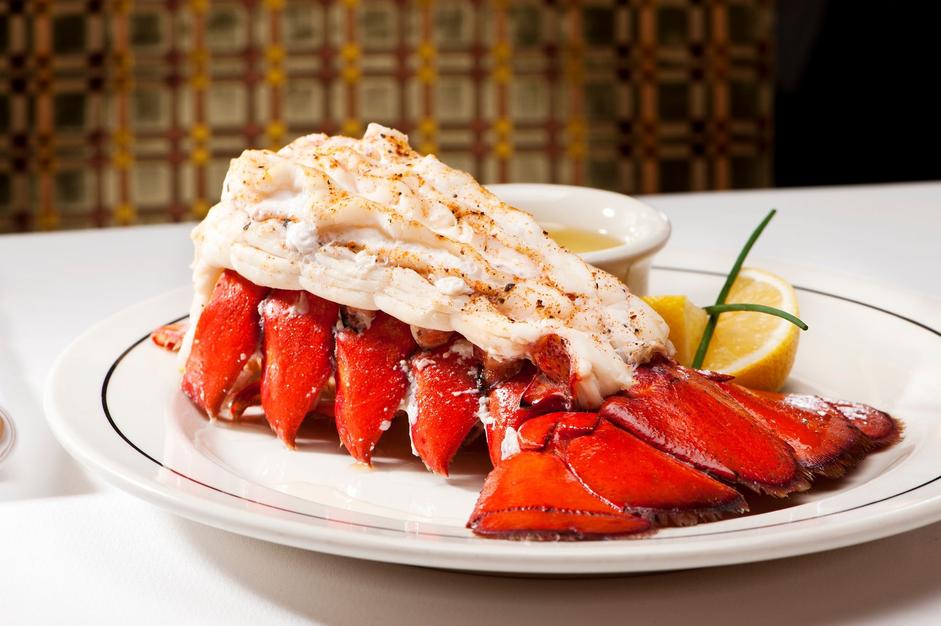 A close up of a lobster tail on a plate