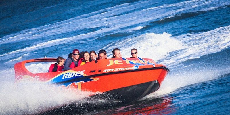 A group of people are riding a jet ski in the ocean.