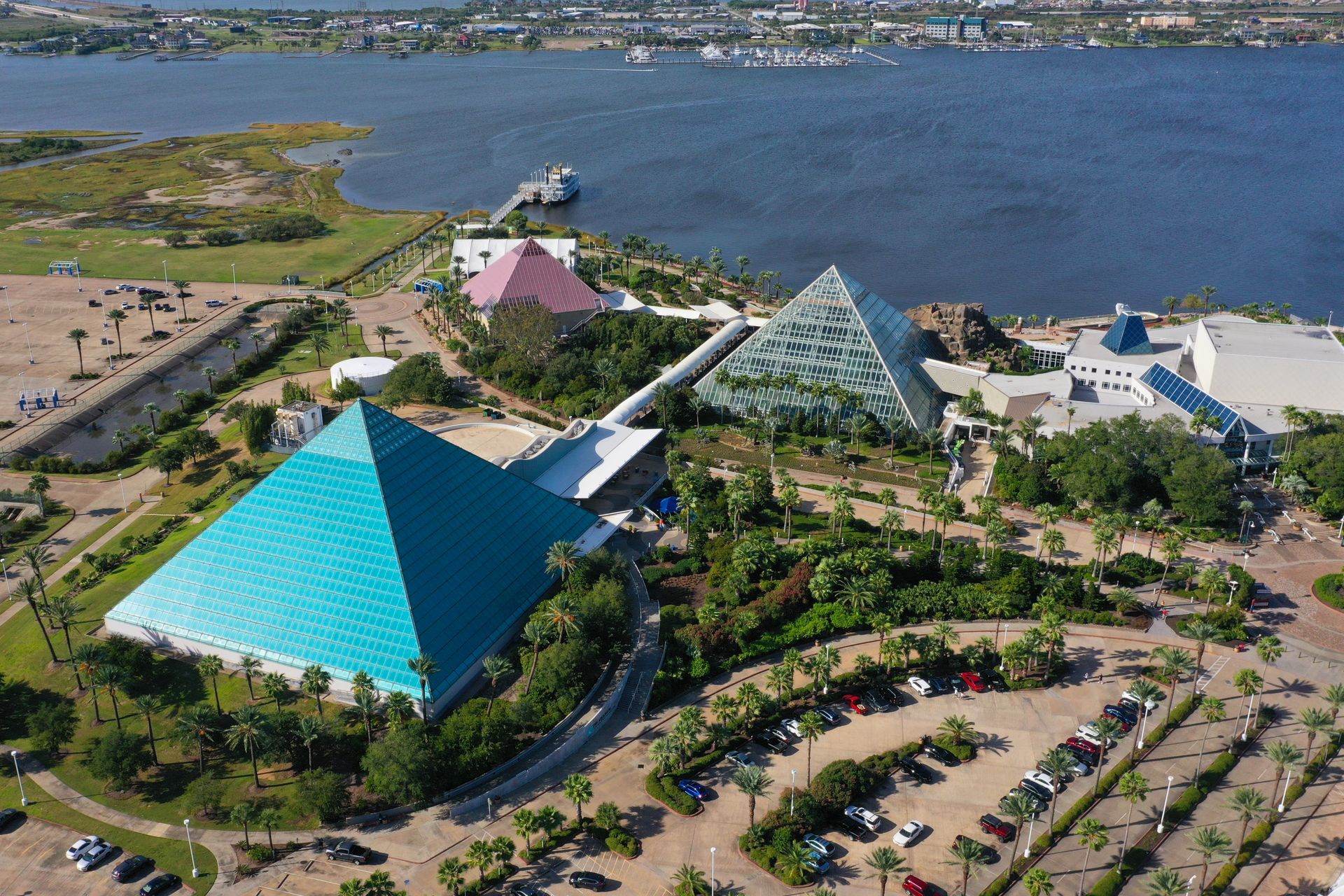 An aerial view of a pyramid shaped building in a park