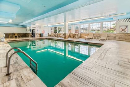 There is a large indoor swimming pool in the middle of the room.