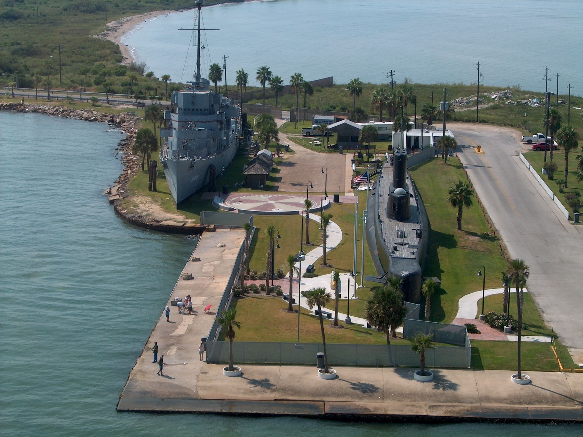 An aerial view of a dock with a submarine in the water