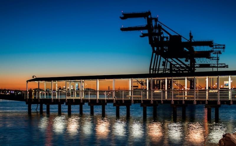 A pier overlooking a body of water at sunset.