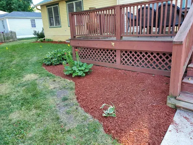 The backyard of a house with a deck and stairs.
