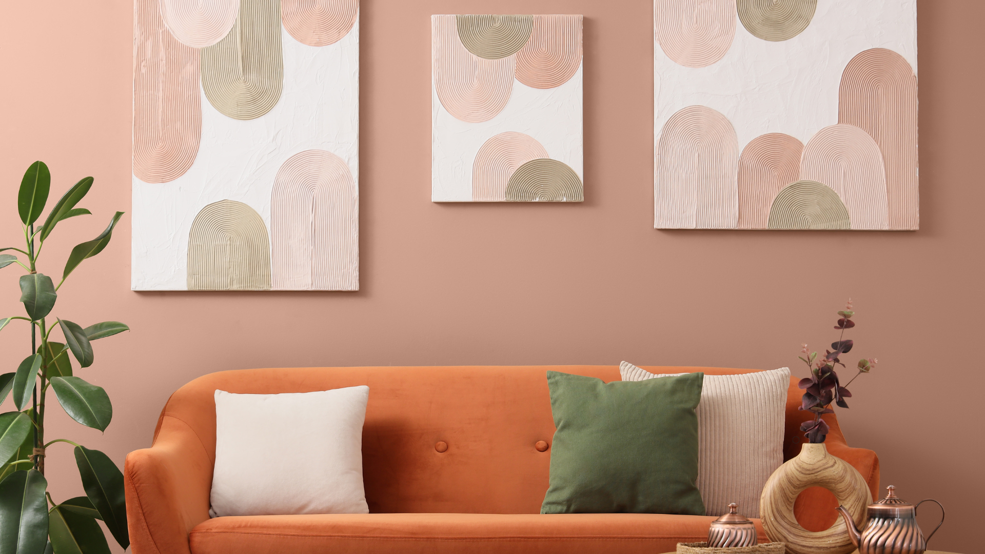 Trendy living room with earthy tones and minimalist abstract art on the wall, complemented by a comfortable orange sofa, decorative plants, and stylish accessories.