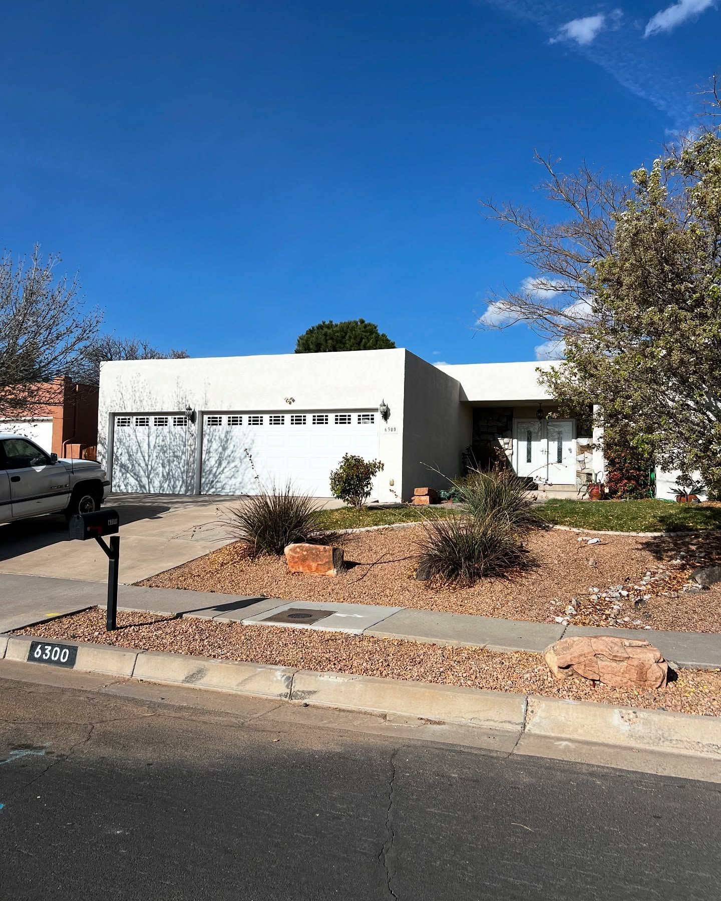 Empty room with French doors, tools, and paint. Preparations for flooring.