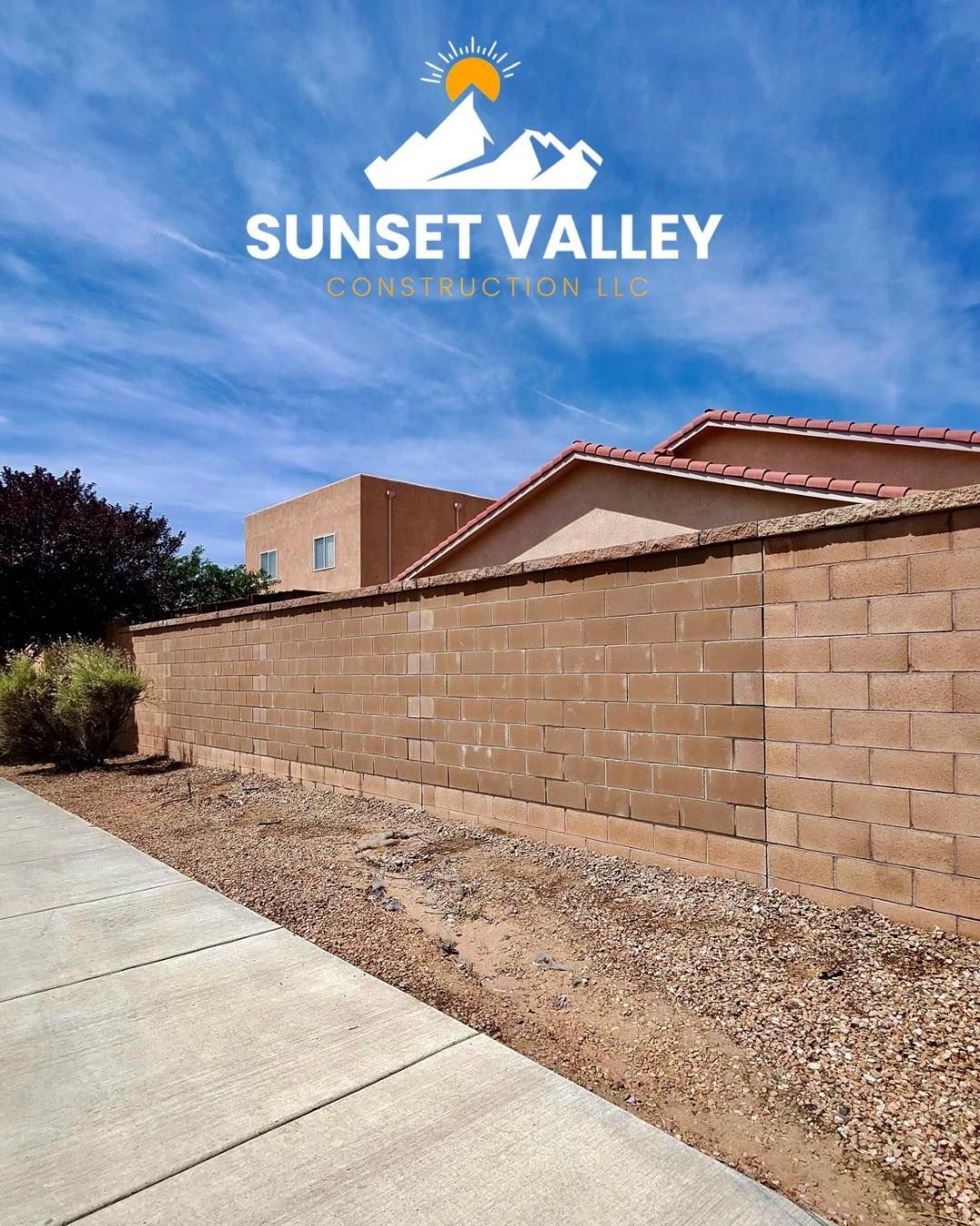 A tan brick wall with a logo 