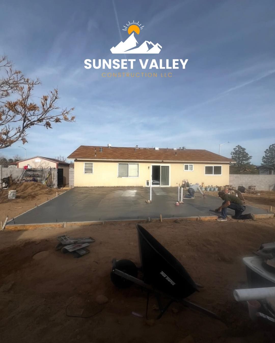 Newly poured concrete patio in front of a tan house; Sunset Valley logo.