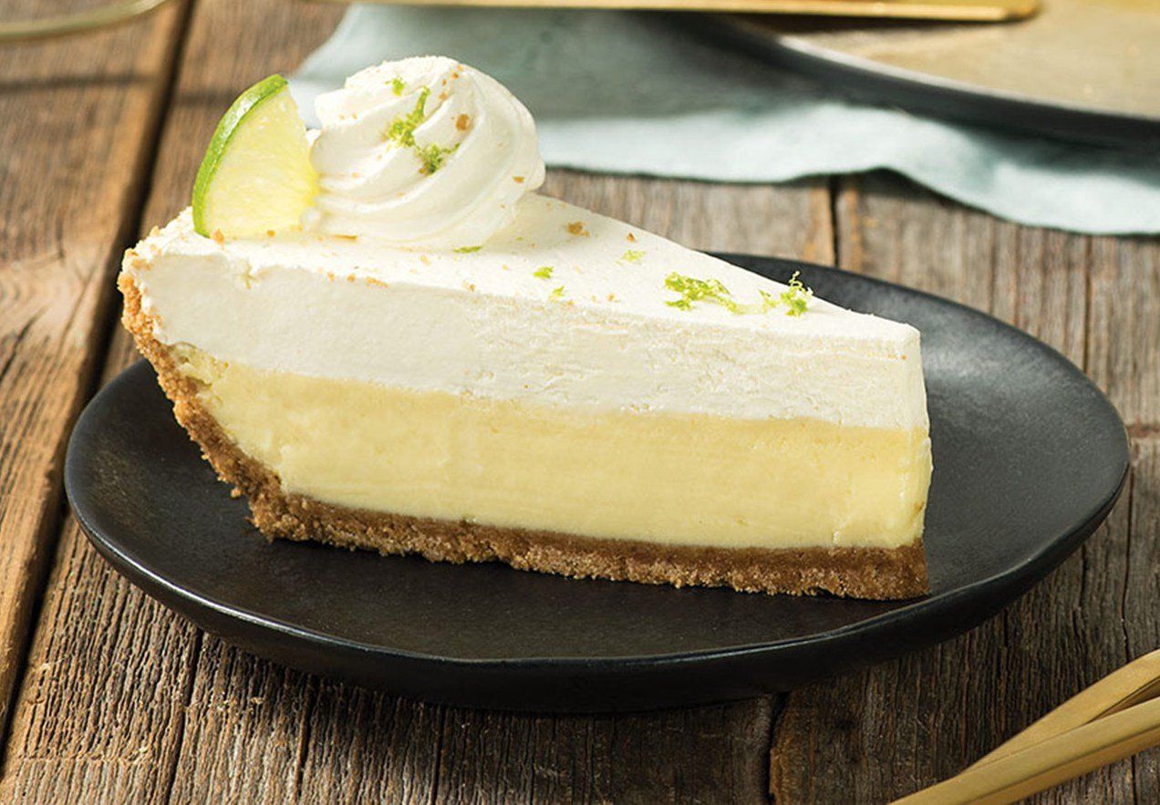 A slice of key lime pie on a green plate.