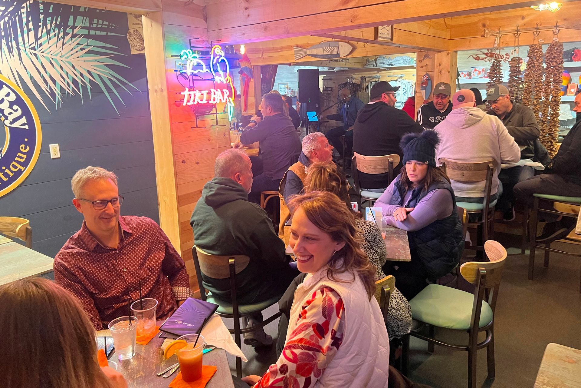 A group of people sitting at indoor dining tables in a restaurant in downtown New Baltimore Michigan