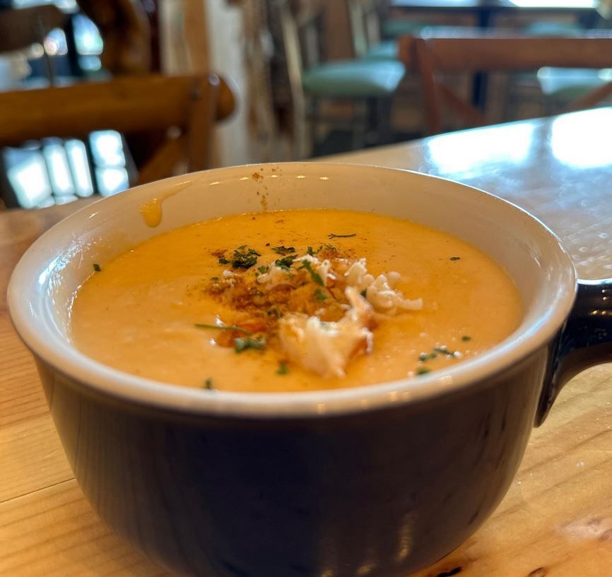 A close up of a bowl of soup on a table.