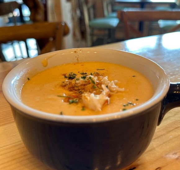 A close up of a bowl of soup on a table.