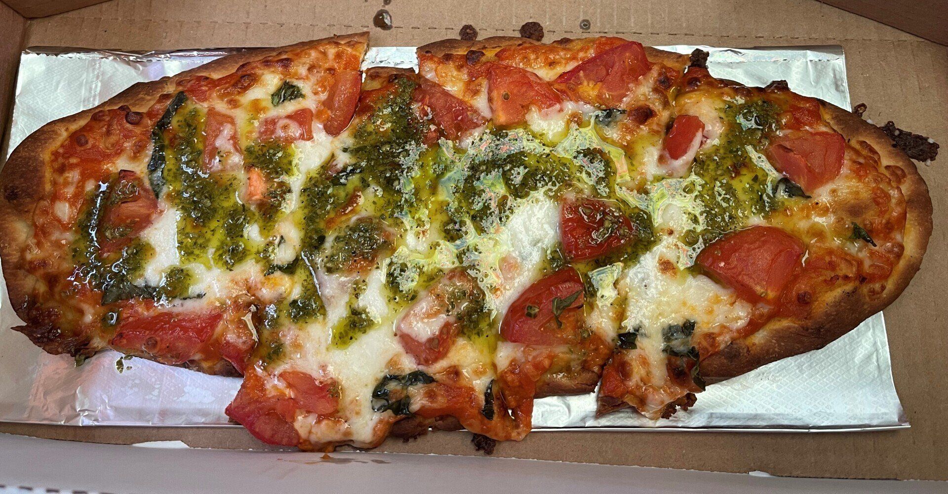 A pizza in a box with a slice missing