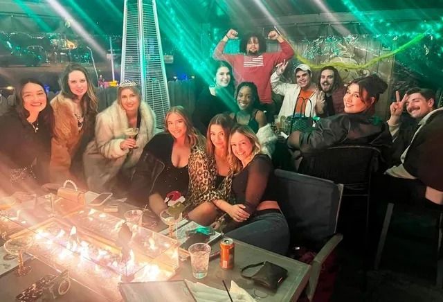 A group of people are posing for a picture at a party.