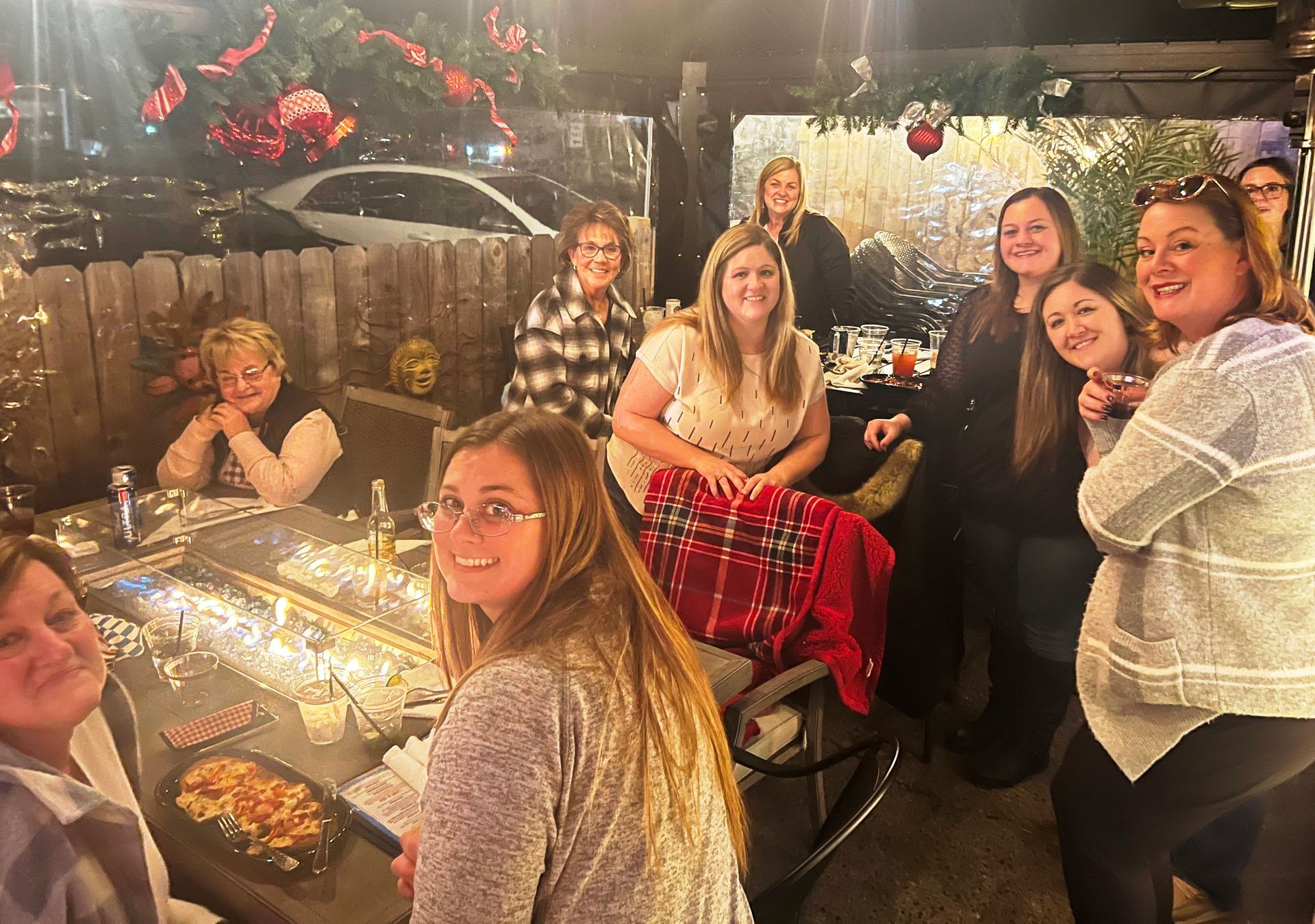 A group of women are posing for a picture at a table at The Bay restaurant, bar, and boutique in downtown New Baltimore Michigan 