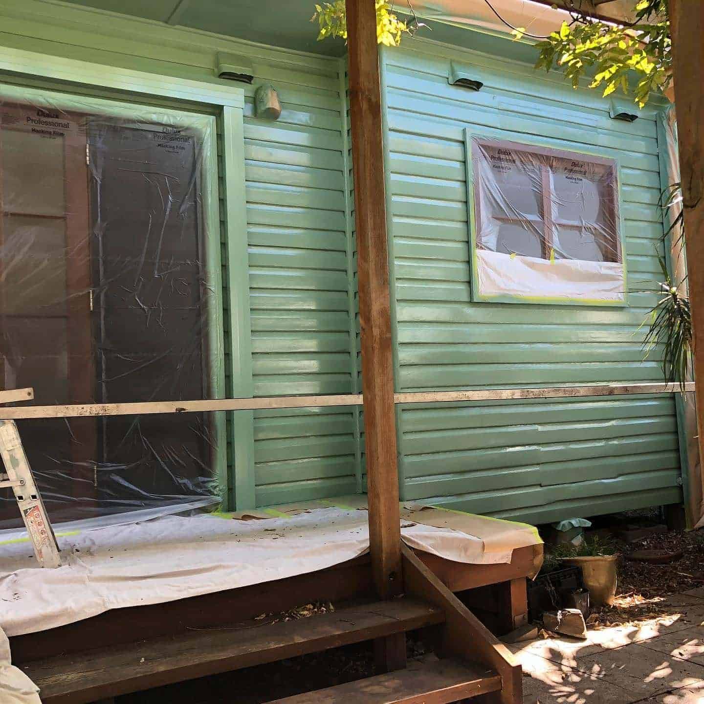 A Green House With Stairs and a Ladder in Front of It — The Big Bearded Painter In Bulahdelah, NSW