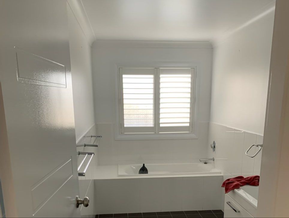 A Bathroom With a Bathtub and a Window — The Big Bearded Painter In Stroud, NSW