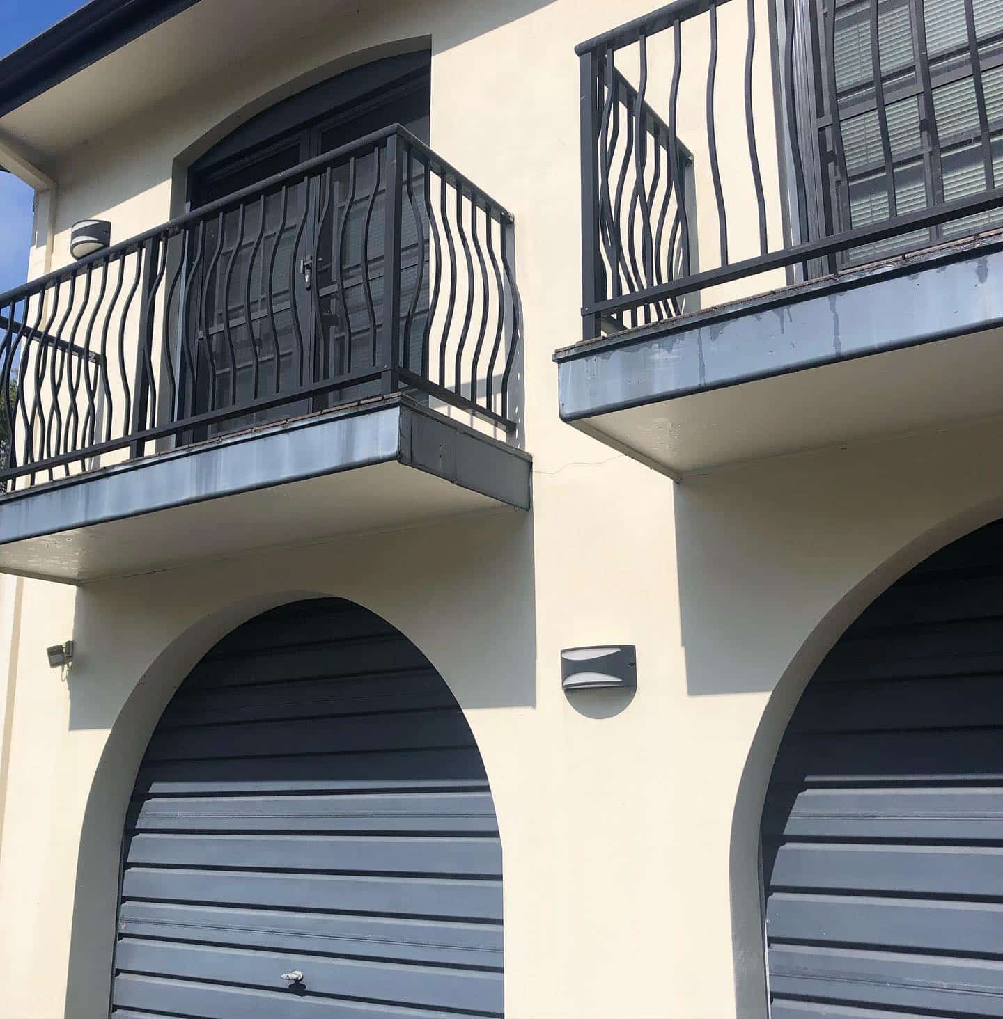 A Building With a Balcony and Two Garage Doors — The Big Bearded Painter In Booral, NSW