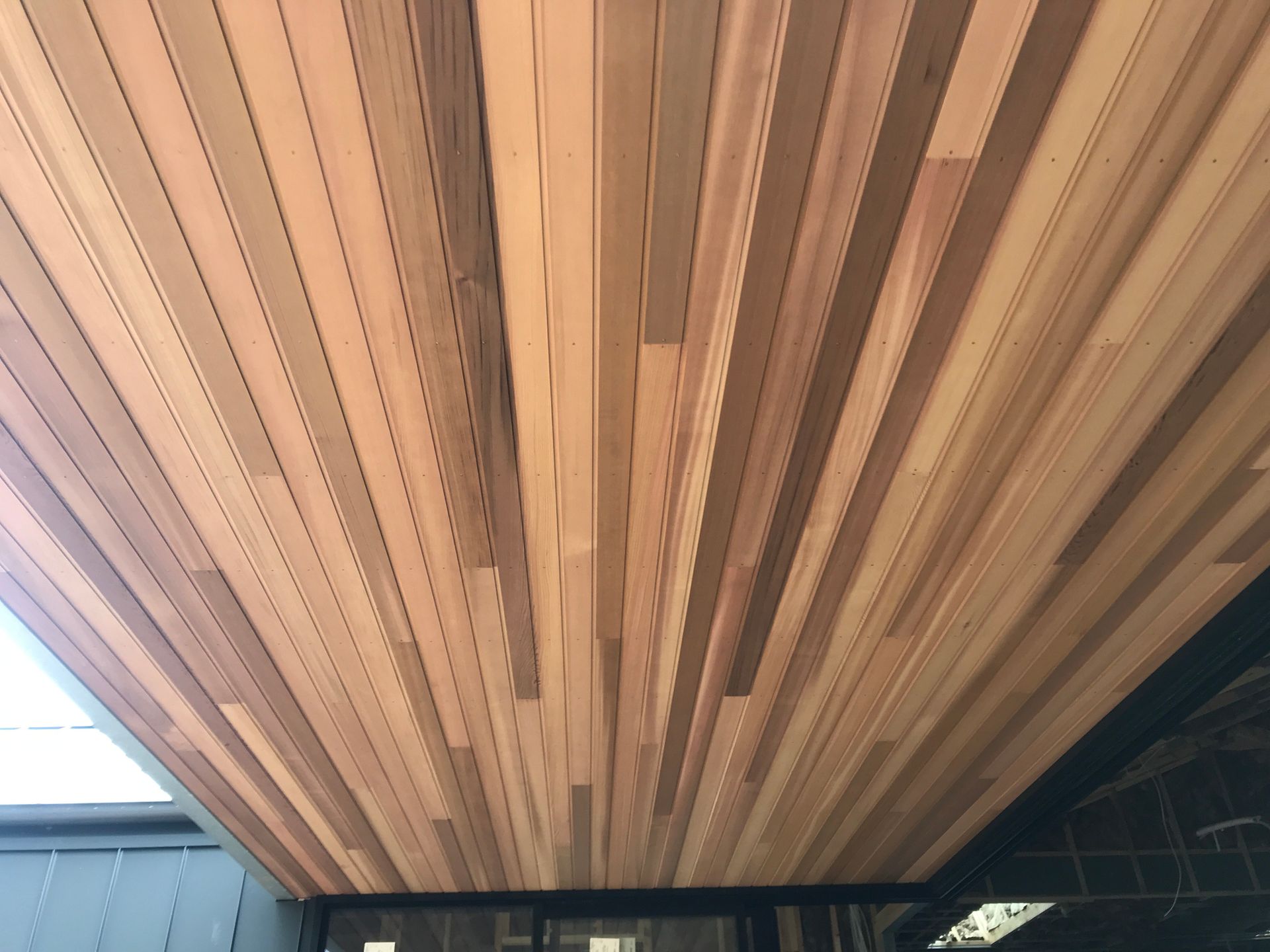 The ceiling of a building is made of wood