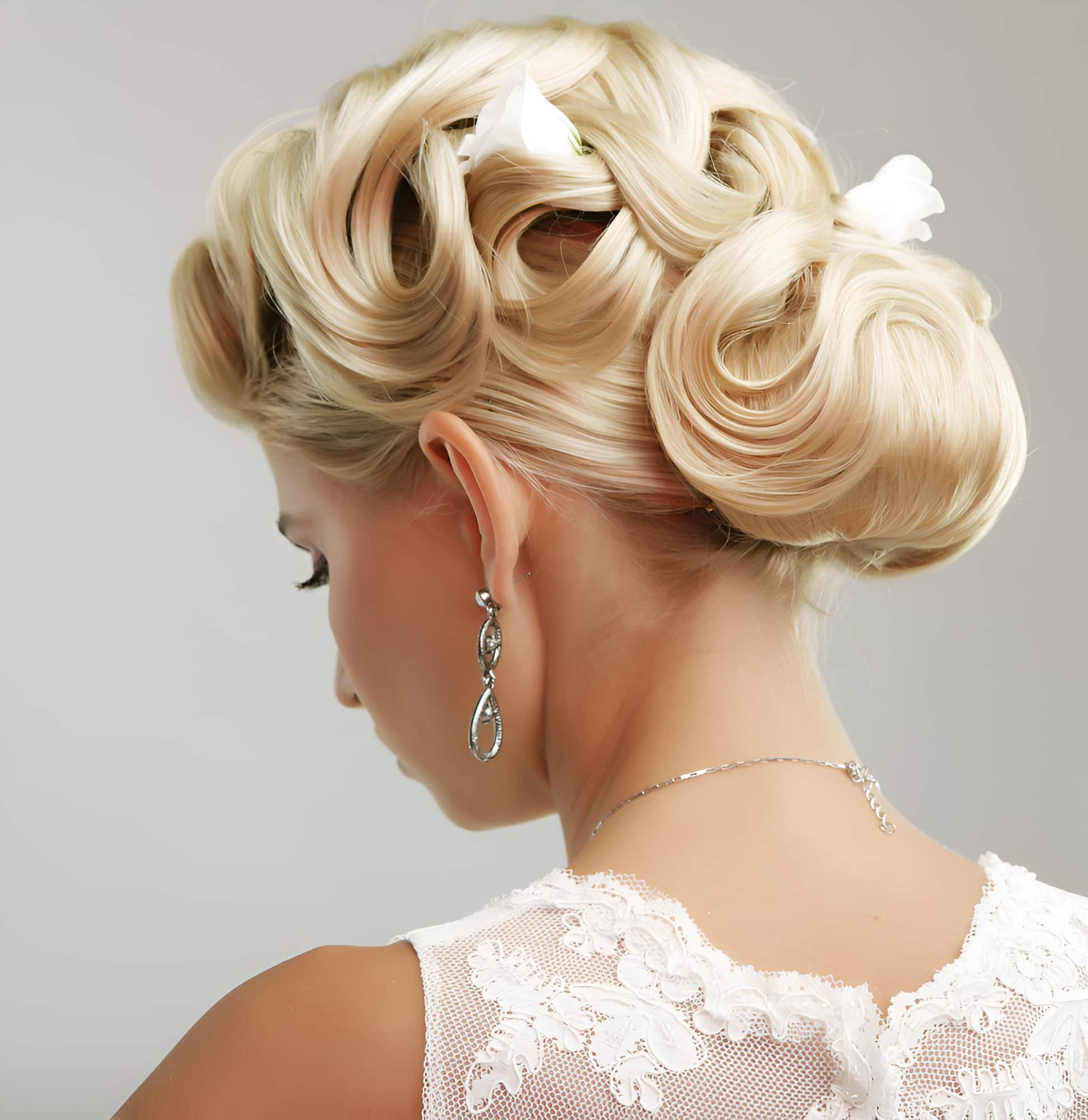 A Woman In A White Lace Dress Has Her Hair In A Bun — Kabello Salon In Airlie Beach, QLD