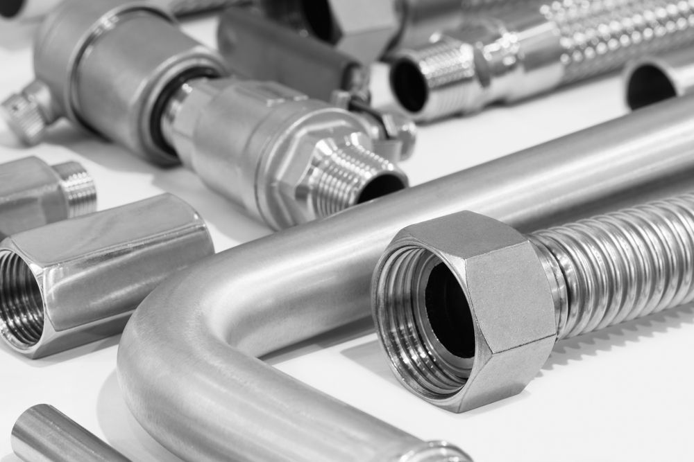 A stainless steel pipe with a warning sign that says sss