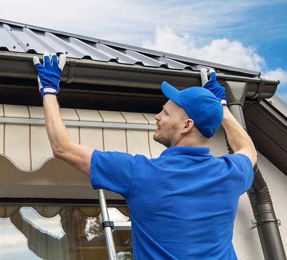 Man Installing New Gutter — Grovetown, GA — Gutters and More