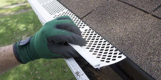 Man Installing Gutter Guard — Grovetown, GA — Gutters and More