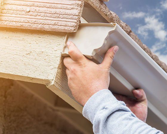 Man Installing Seamless Gutter — Grovetown, GA — Gutters and More