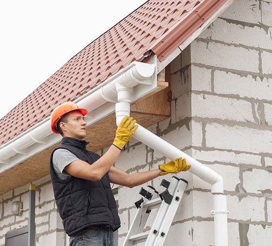 Man Installing Gutter System — Grovetown, GA — Gutters and More