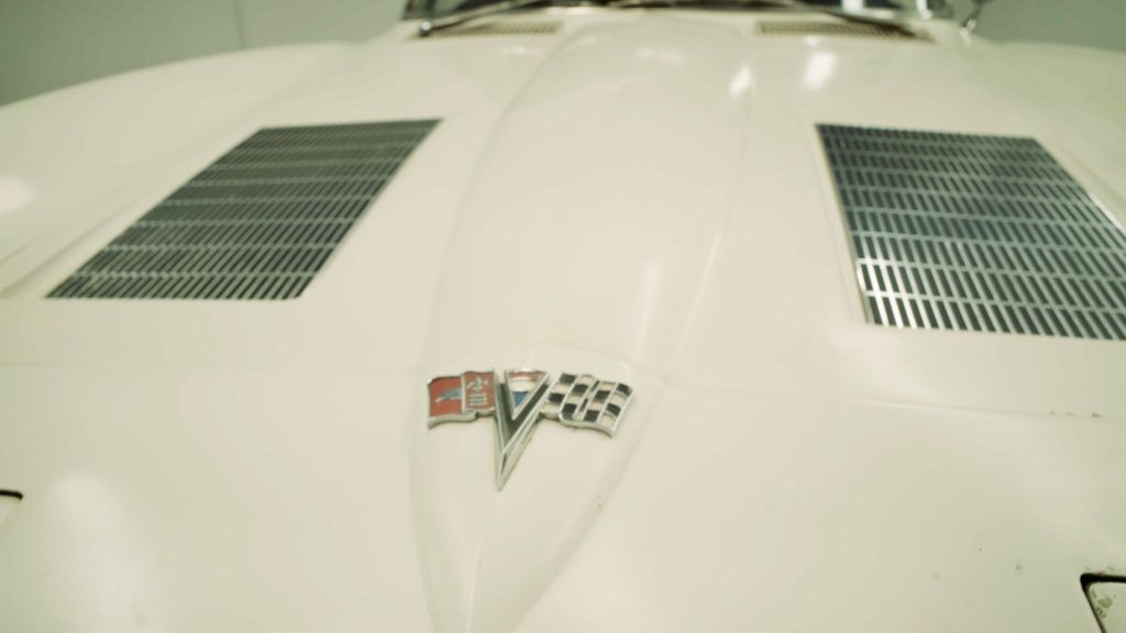 White classic Corvette hood with vents and emblem.