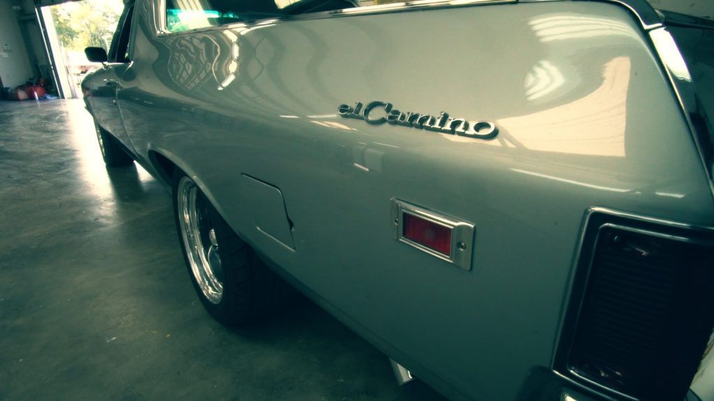 Silver Chevrolet El Camino parked indoors.