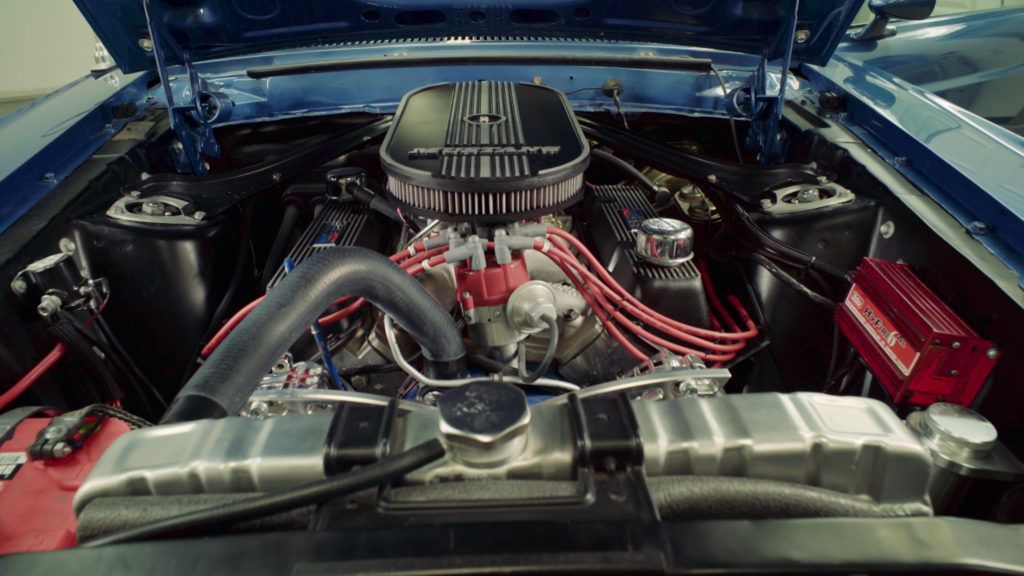 Blue classic car engine, showing various components and wiring.