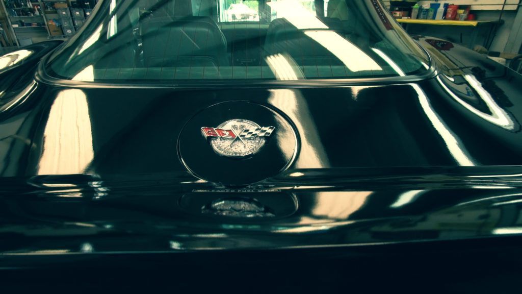 Black Corvette rear with logo on the trunk.