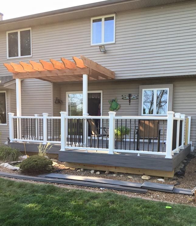 A house with a window on the side of it and a lawn in front of it.