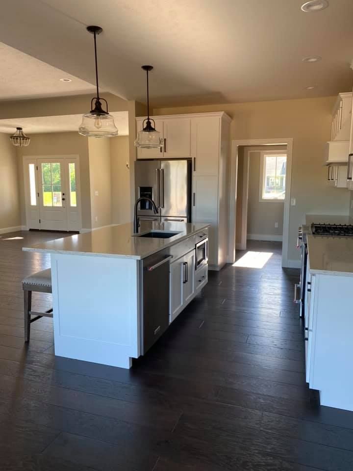 A house with a window on the side of it and a lawn in front of it.