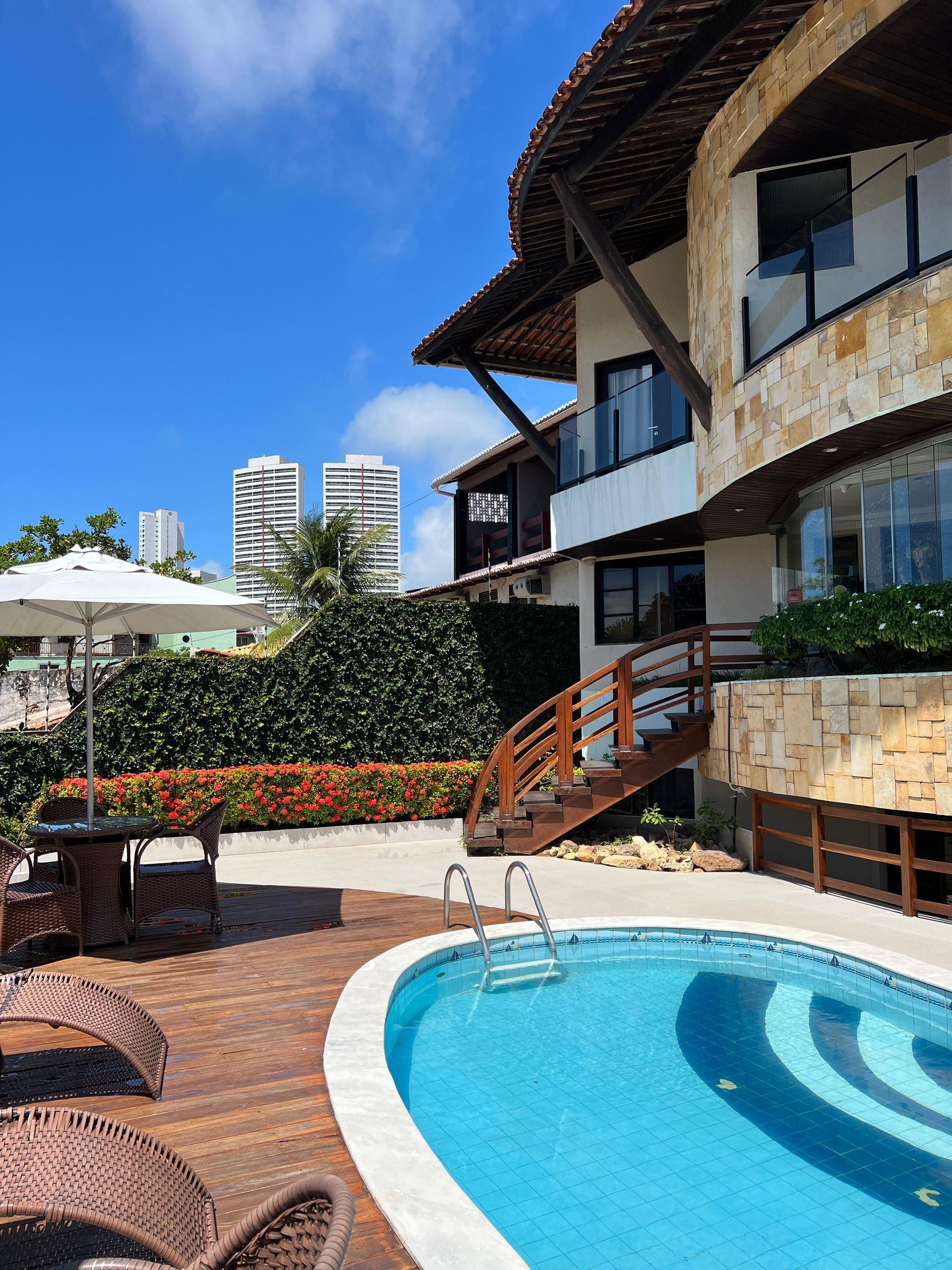 Há uma grande piscina com uma cachoeira ao fundo.