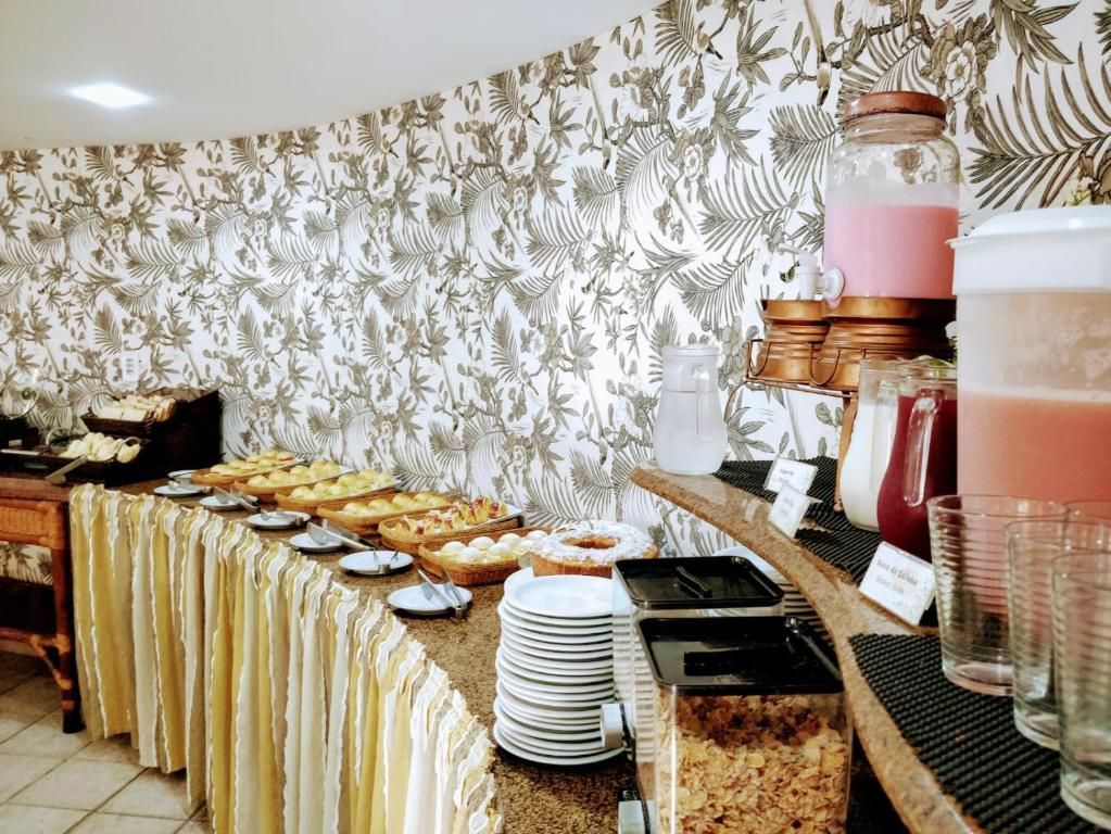 Uma mesa de bufê com muita comida e bebida.