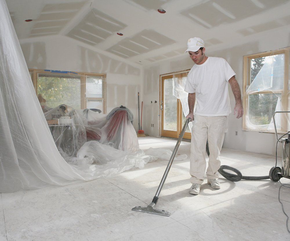 Man Cleaning The Floor Using Vacuum — Laguna Niguel, CA — Margaret’s Cleaning Service