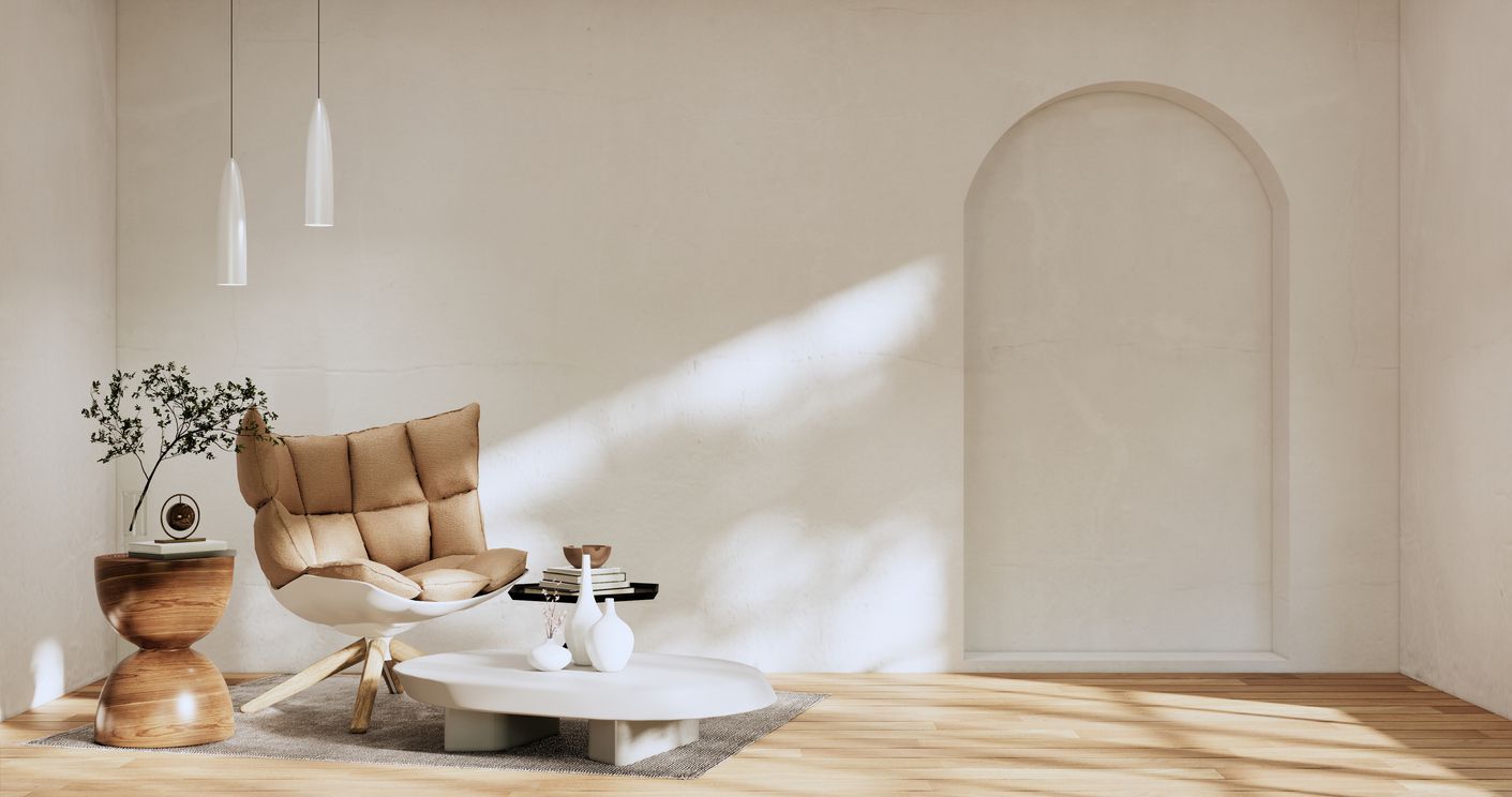 a living room with a chair , table and vases .