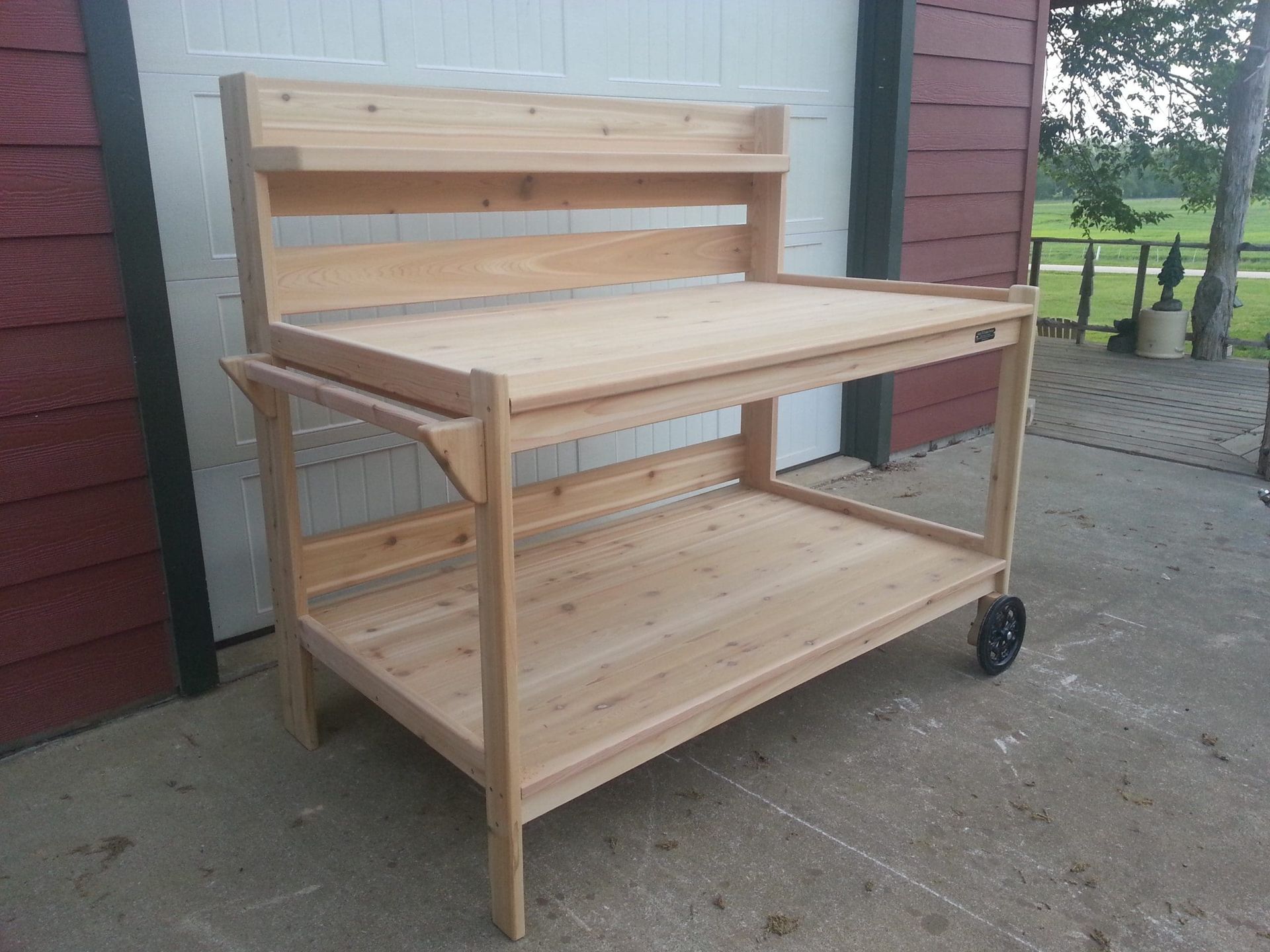 A wooden table with wheels sits in front of a garage door