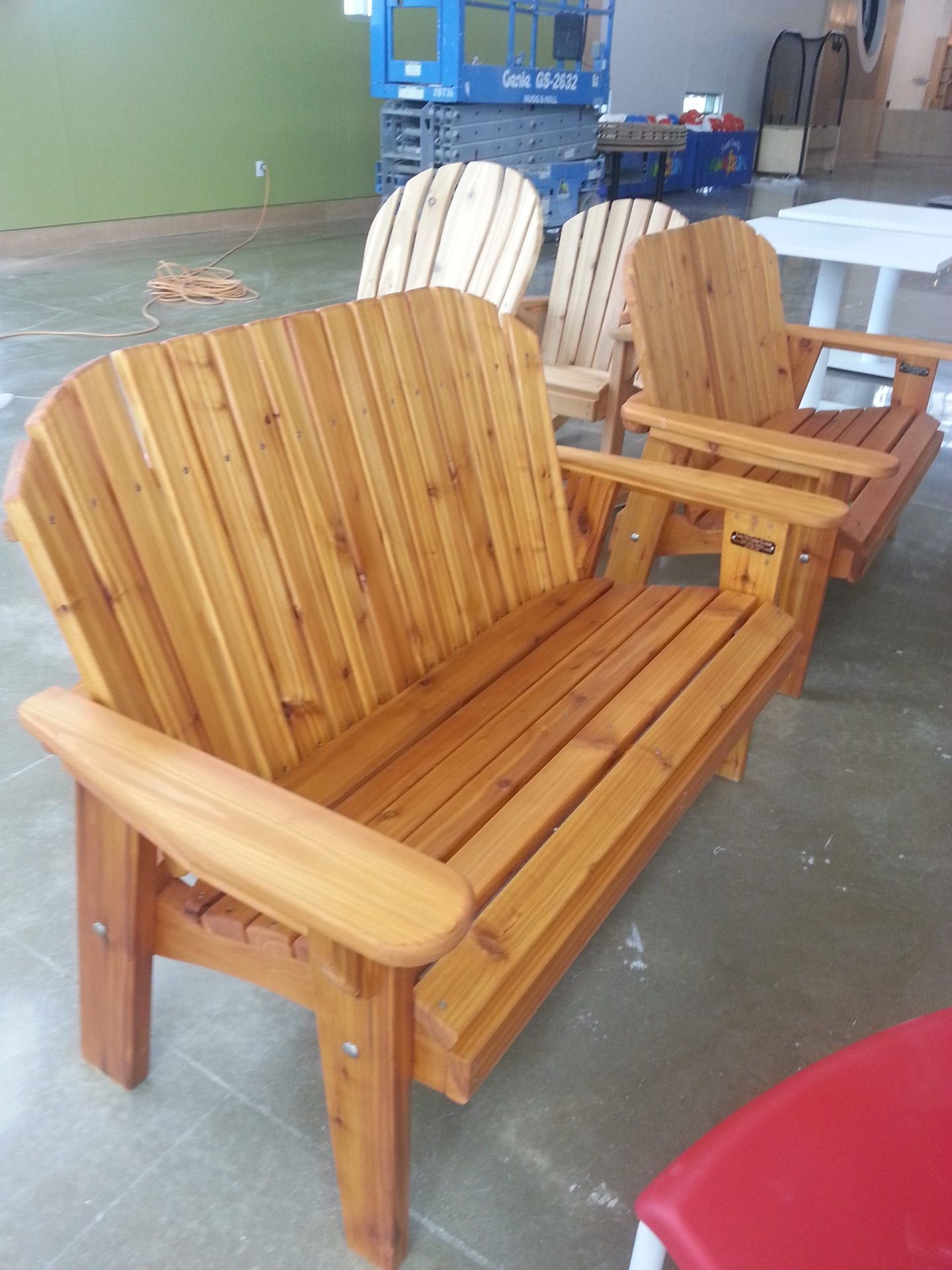 A row of wooden chairs are lined up in a room.