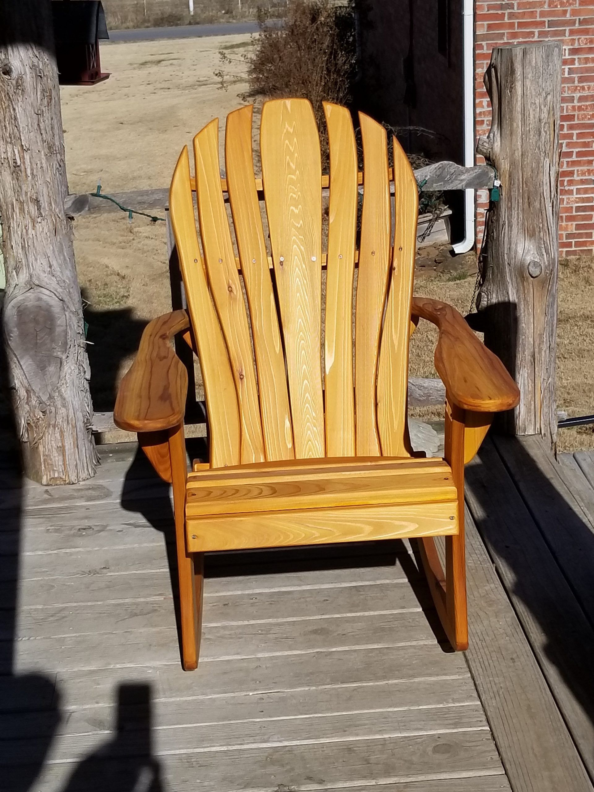 A wooden chair is sitting on a wooden deck