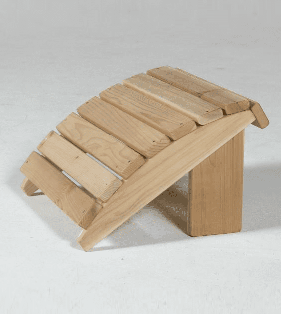 A wooden ottoman sits on a white surface