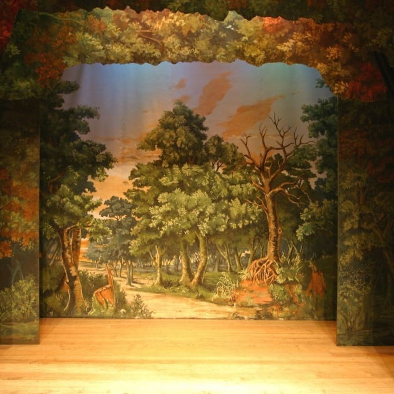 A stage with a painting of trees on it