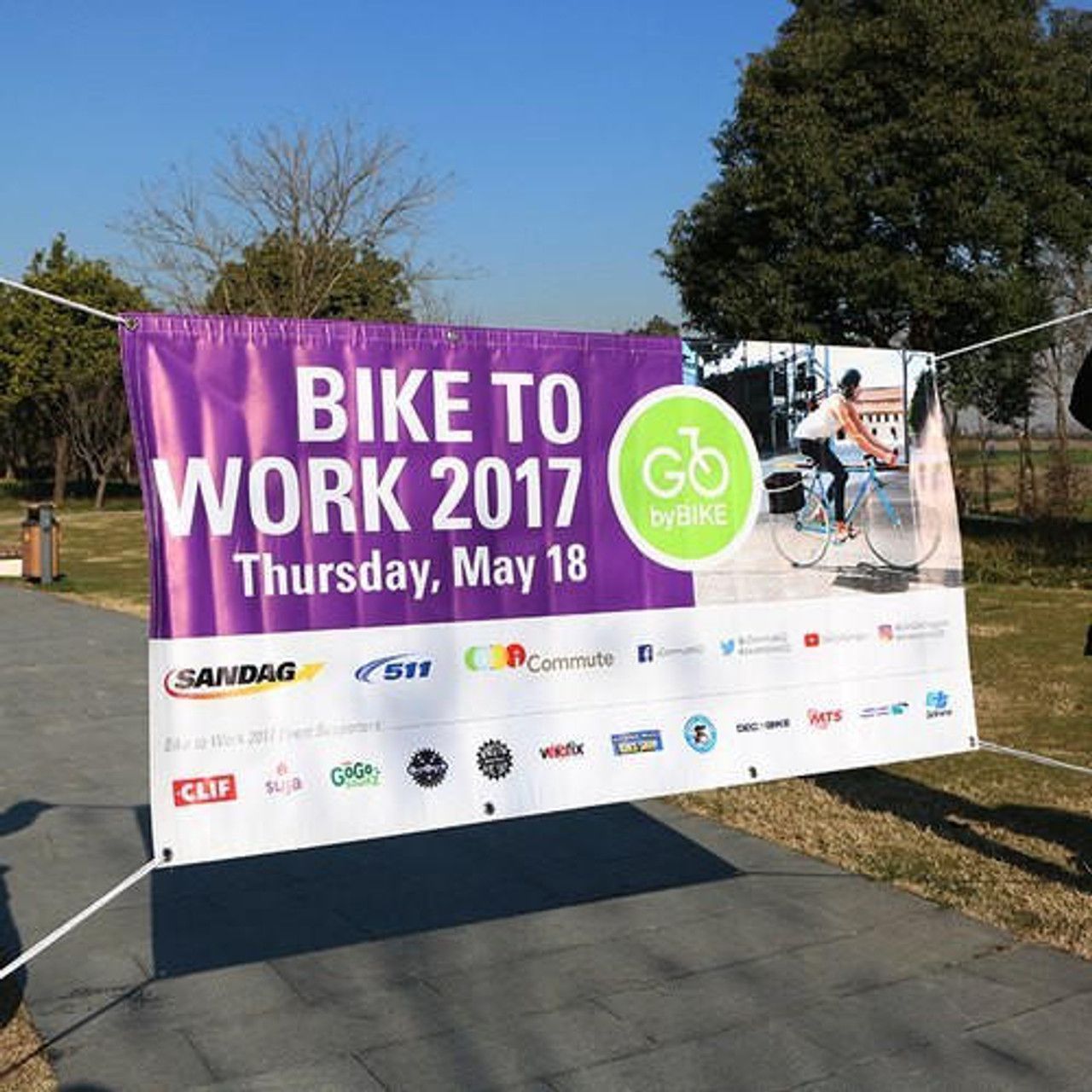 A purple and white banner that says bike to work 2017
