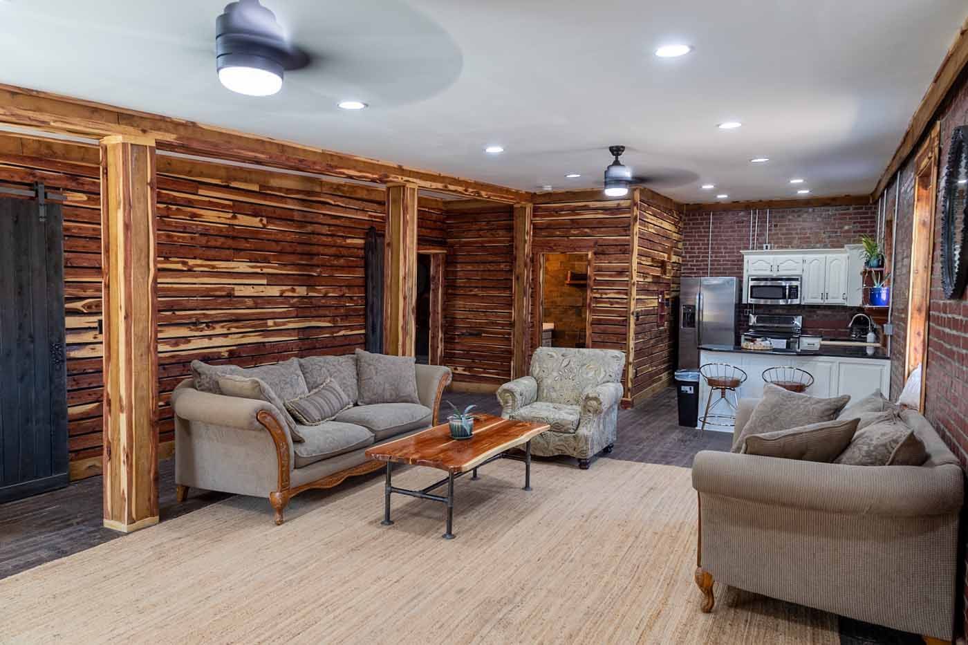 A living room filled with furniture and a ceiling fan.