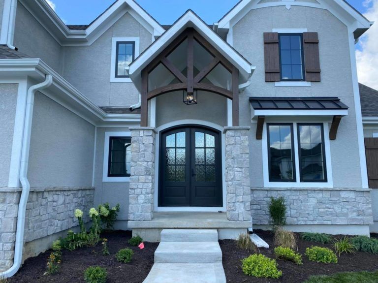 The front of a house with a black door
